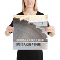 A workplace safety poster depicting a close up of a table saw blade in a workshop with a safety slogan on the bottom half of poster.
