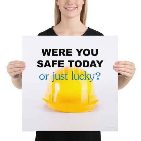 A workplace safety poster showing a yellow hard hat on a plain white background with the slogan were you safe today, or just lucky?