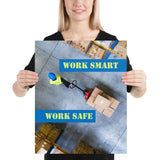 A safety poster showing a bird's-eye view of a worker in a warehouse pulling boxes on a pallet jack with the slogan work smart, work safe.