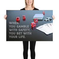 A workplace safety poster of a glossy black table with red dice, playing cards, and poker chips strewn everywhere with a safety slogan in the bottom left corner.