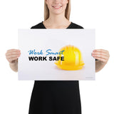 A safety poster showing a close-up of a yellow hard hat on a white background with the slogan work smart and work safe.