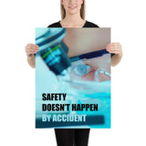 Safety poster of a close up of a woman's eyes wearing safety glasses inspecting a sample on a microscope with safety slogan written at the bottom.