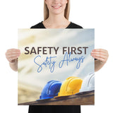 A workplace safety poster showing a white, a yellow, and a blue hardhat sitting on a wall with the slogan safety first, safety always.