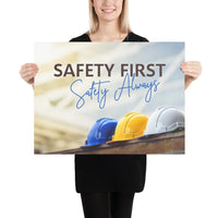 A workplace safety poster showing a white, a yellow, and a blue hardhat sitting on a wall with the slogan safety first, safety always.