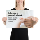 A safety poster showing a close-up of a baby's tiny hand wrapped around their parent's finger with the slogan take care of yourself at work so you can take care of them at home.