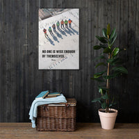 A workplace safety poster showing an aerial view of construction workers in reflective vests standing in a line on top of a building with their shadows being cast on the building with the quote no one is wise enough by themselves by Plautus.