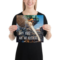 A safety poster showing a close-up a chainsaw sawing into a log of wood with sawdust flying everywhere and the slogan safe jobs are no accident.