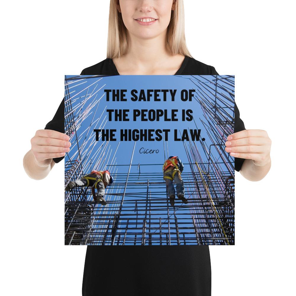 A safety poster showing construction workers scaling rebar with a bright blue sky as the background and a safety quote in black block text.