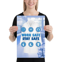 A workplace safety poster showing a blurred blue tinted lab in the background with a bright white lab coat and different blue infographic bubbles of PPE around the slogan work safe, stay safe.