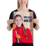 A workplace safety poster showing a warehouse worker wearing gloves and safety glasses and holding a broom and smiling with the slogan work smart and work safe.