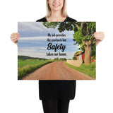 A workplace safety poster showing a beautiful sunny day in the countryside with a red barn on the right of a dirt road and text above the road saying my job provides the paycheck but safety takes me home.