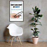 An eye safety slogan showing a close up of a hand presenting out safety glasses with a safety slogan in blue text above.