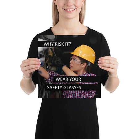A safety poster showing a female industrial worker donned in safety glasses, a hard hat, and safety gloves with the slogan "Why Risk It? Wear Your Safety Glasses."