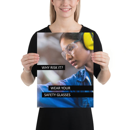 A safety poster showing a close up of a woman working while wearing ear muffs and safety glasses with the slogan "Why Risk It? Wear Your Safety Glasses."