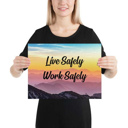 A safety poster showing a mountain range with a beautiful gradient in the sky of blue, yellow, and pink with the safety slogan "Live Safely Work Safely."