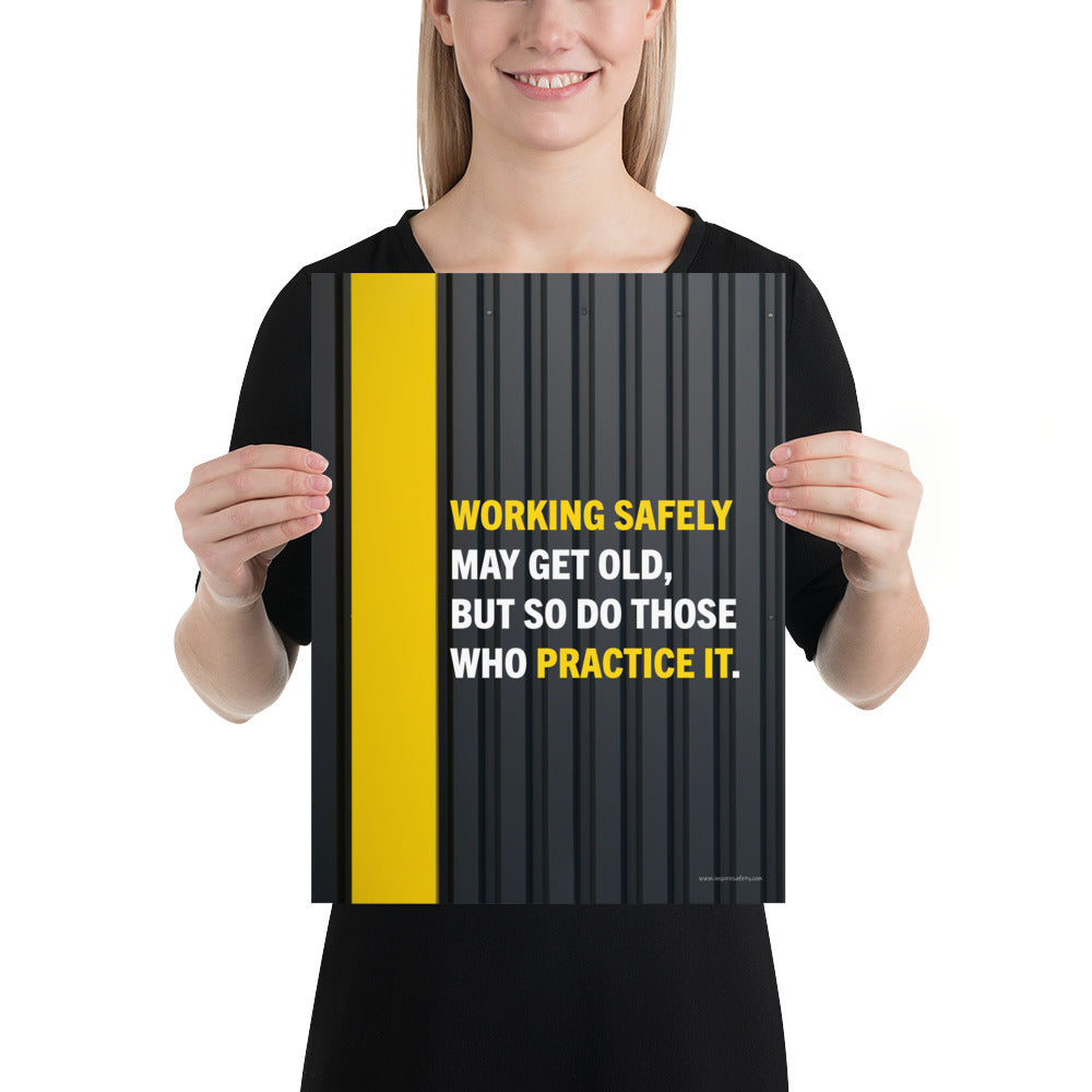 A construction safety poster showing a black metal wall with a yellow stripe with the slogan "Working safely may get old, but so do those who practice it."