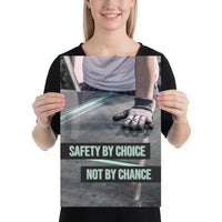 A workplace safety poster showing a close-up of a worker's hands grabbing panes of glass with gloves on with the slogan safety by choice not by chance.