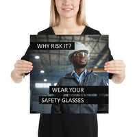 An eye safety poster showing a man in a white hard hat and safety glasses in a warehouse with the slogan "Why risk it? Wear your safety glasses."