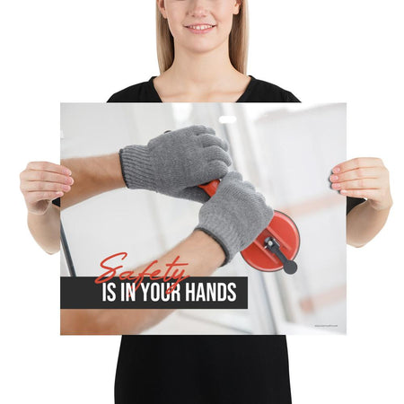 A workplace safety poster showing a close-up of a worker's hands wearing gloves while installing windows with the slogan safety is in your hands.