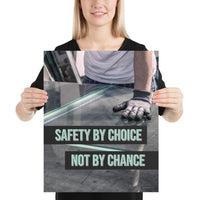 A workplace safety poster showing a close-up of a worker's hands grabbing panes of glass with gloves on with the slogan safety by choice not by chance.