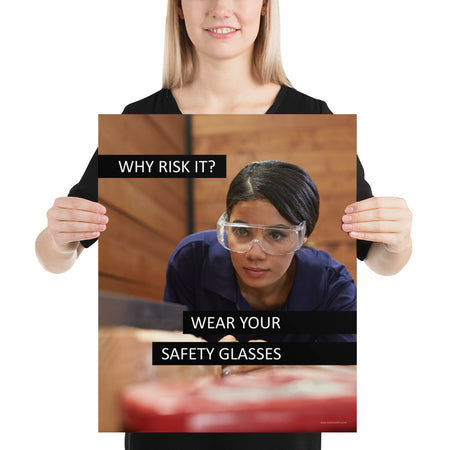 A safety poster showing a woman using a table saw to cut wood wearing safety glasses with the slogan "Why Risk It? Wear Your Safety Glasses."