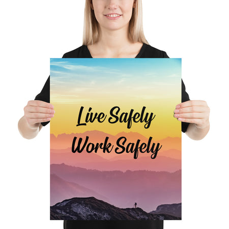 A safety poster showing a mountain range with a beautiful gradient in the sky of blue, yellow, and pink with the safety slogan "Live Safely Work Safely."