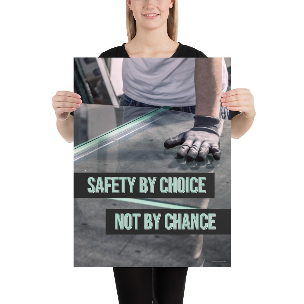 A workplace safety poster showing a close-up of a worker's hands grabbing panes of glass with gloves on with the slogan safety by choice not by chance.