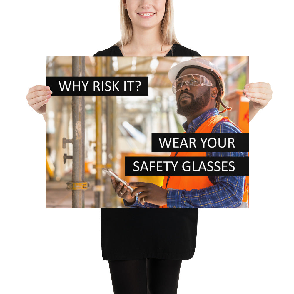 A safety poster showing a man in a reflective vest, hard hat, and safety glasses working with the slogan "Why risk it? Wear your safety glasses."