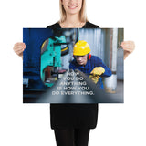 A safety poster showing a man in a yellow hard hat, red earmuffs and safety glasses, working in a factory with the slogan "HOw you do anything is how you do everything" below him.