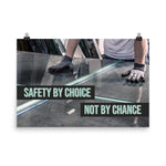 A workplace safety poster showing a close-up of a worker's hands grabbing panes of glass with gloves on with the slogan safety by choice not by chance.
