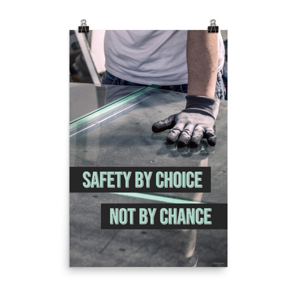 A workplace safety poster showing a close-up of a worker's hands grabbing panes of glass with gloves on with the slogan safety by choice not by chance.