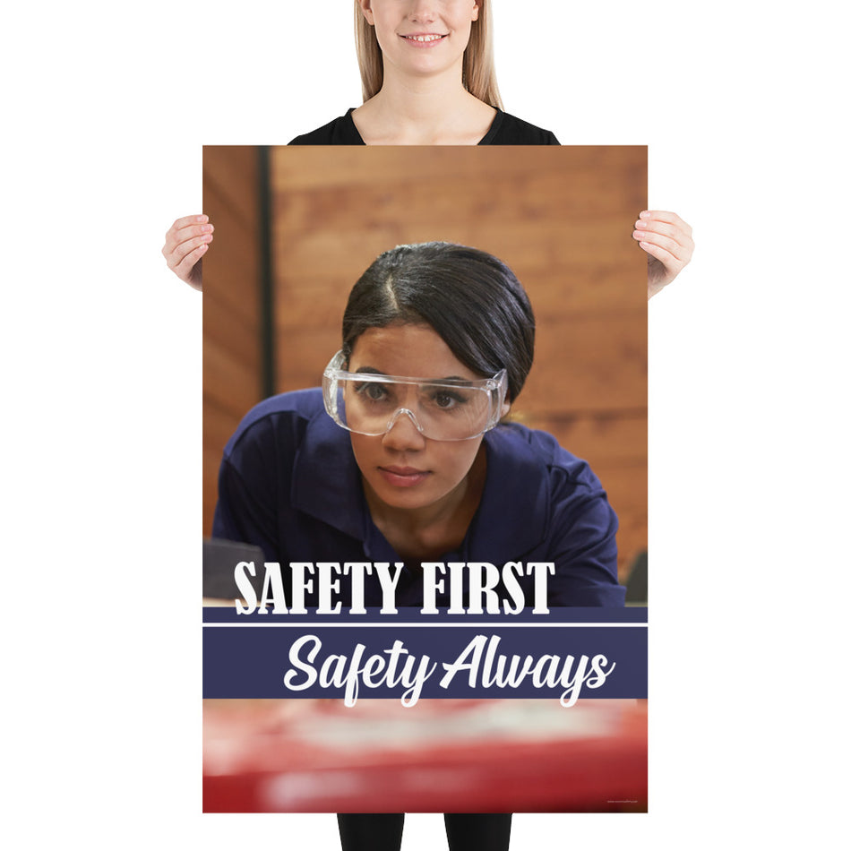 A woman in safety glasses working in a woodshop with the slogan "Safety first, safety always" below her.