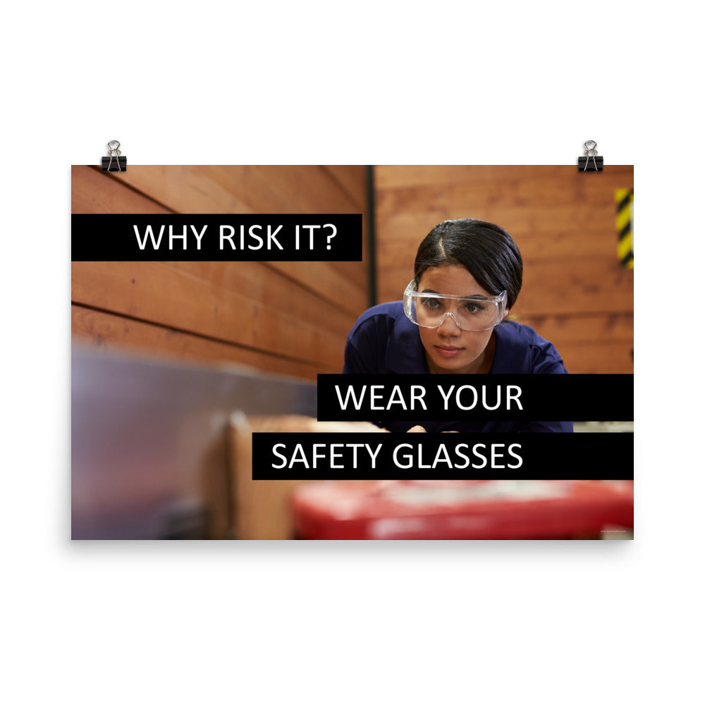 A safety poster showing a woman using a table saw to cut wood wearing safety glasses with the slogan "Why Risk It? Wear Your Safety Glasses."
