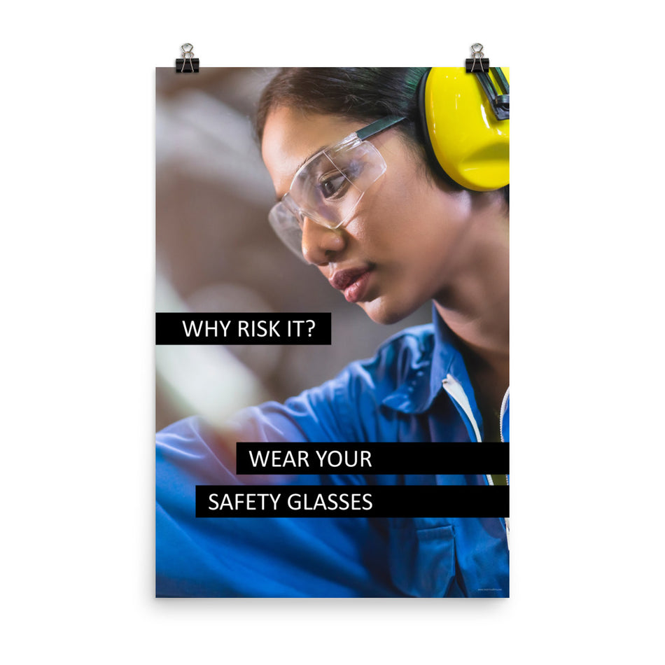 A safety poster showing a close up of a woman working while wearing ear muffs and safety glasses with the slogan "Why Risk It? Wear Your Safety Glasses."