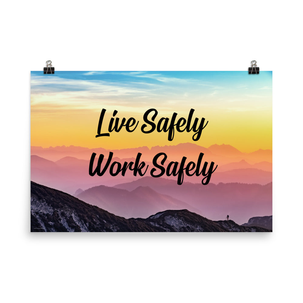 A safety poster showing a mountain range with a beautiful gradient in the sky of blue, yellow, and pink with the safety slogan "Live Safely Work Safely."