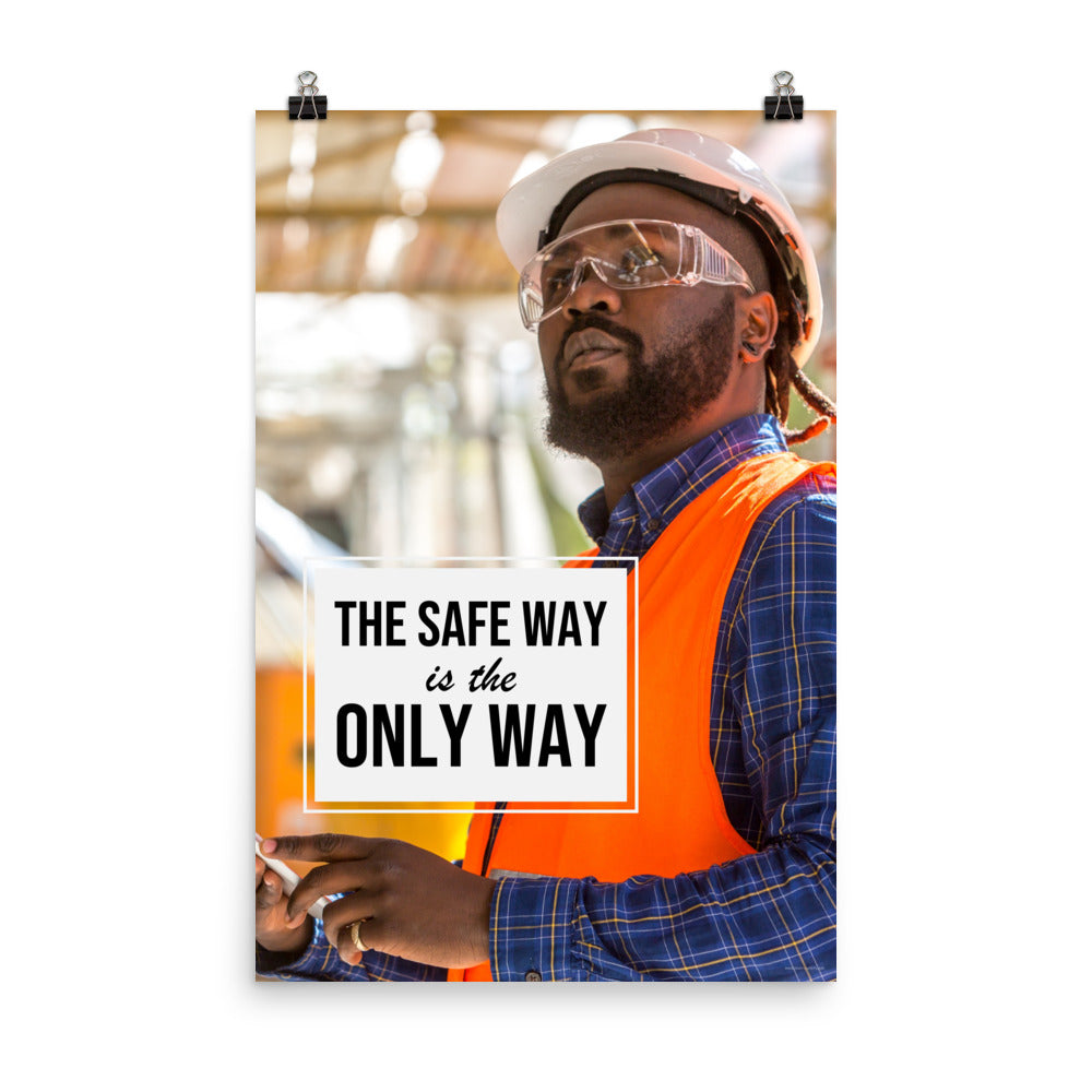 A construction worker in an orange vest, hard hat, and safety glasses working intently with the slogan "The safe way is the only way."