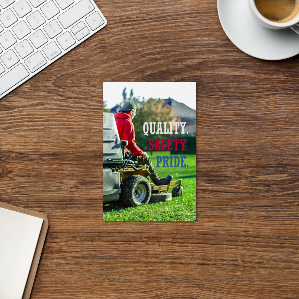 A workplace safety print showing a man mowing a lawn on a sitting mower with the words quality, safety, pride in white, red, and blue, respectively.