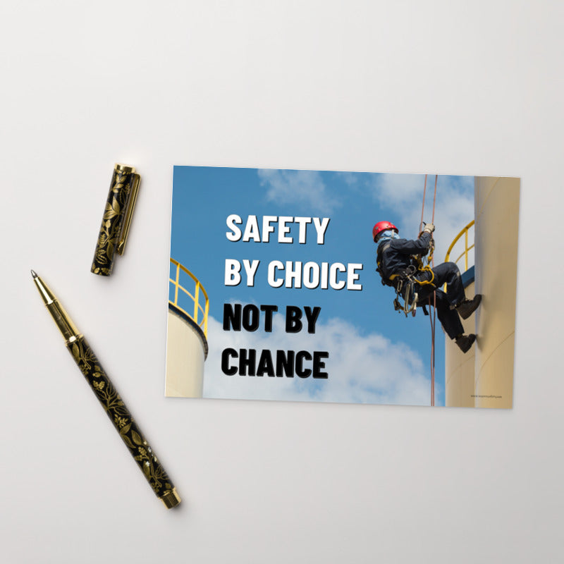 A safety mini print of a fully harnessed man wearing a hard hat scaling the side of a building with a bright blue sky and clouds in the background with the text safety by choice, not by chance in bold text to his left.