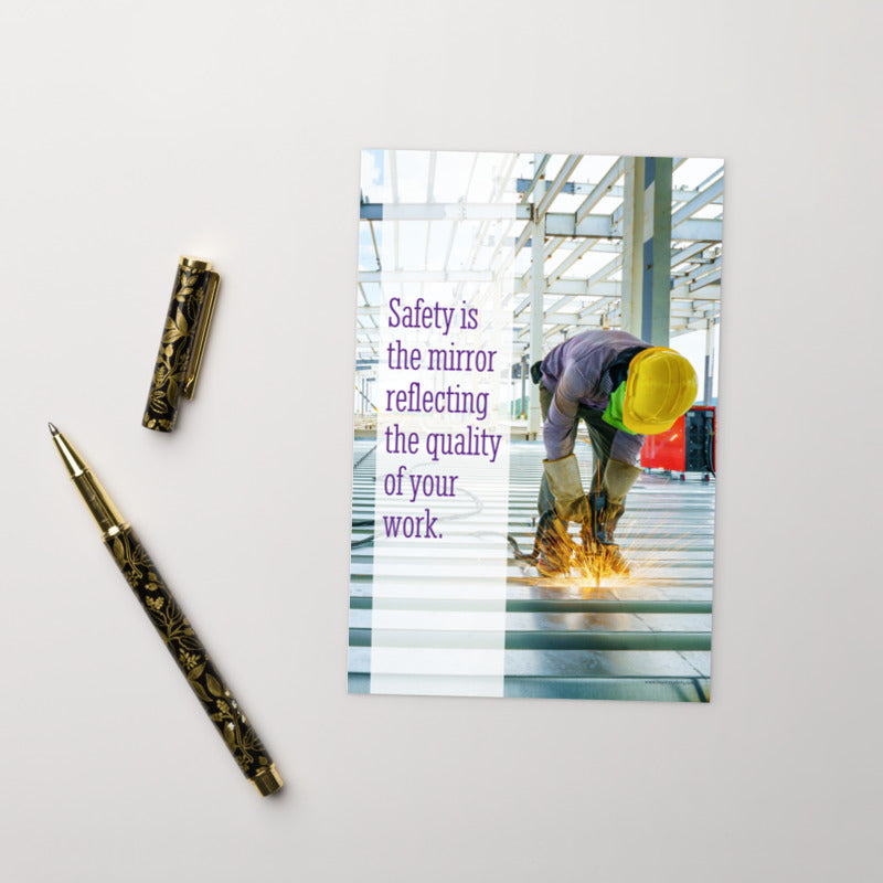 A workplace safety print showing a construction worker wearing all of the proper PPE and bending over to work on a huge sheet of metal with sparks flying everywhere with the slogan safety is the mirror reflecting the quality of your work.