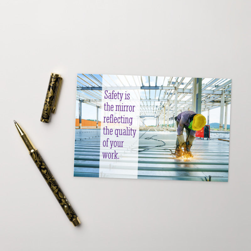 A workplace safety print showing a construction worker wearing all of the proper PPE and bending over to work on a huge sheet of metal with sparks flying everywhere with the slogan safety is the mirror reflecting the quality of your work.