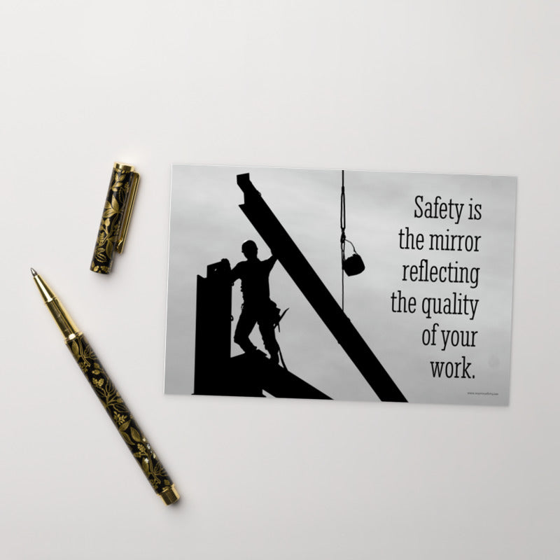 A workplace safety print showing a construction ironworker working on a construction site with everything silhouetted black with a light grey background and with the slogan safety is the mirror reflecting the quality of your work.