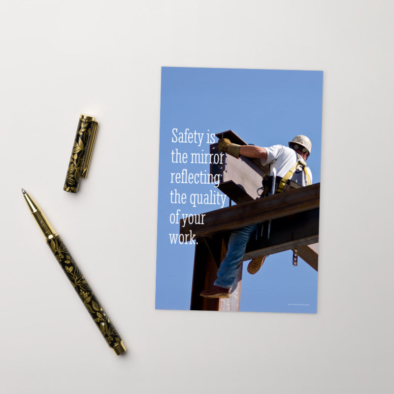 A workplace safety print showing a construction ironworker on steel beams in a hardhat and safety harness with a bright blue sky in the background with the slogan safety is the mirror reflecting the quality of your work.