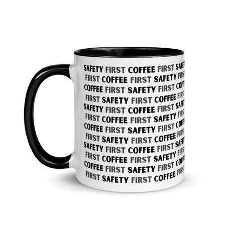 White ceramic mug with black repeating text that says "Safety First, Coffee First" with a black rim, inside, and handle.