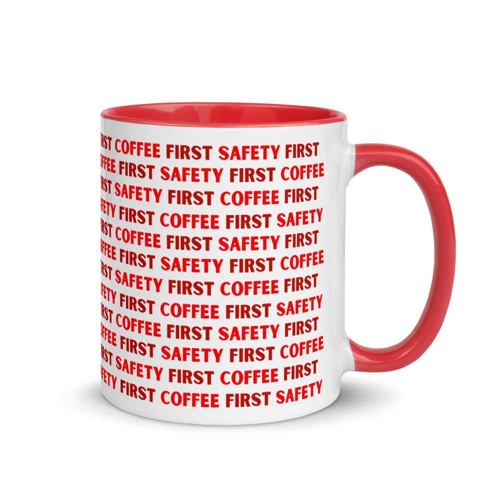 White ceramic mug with red repeating text that says "Safety First, Coffee First" with a red rim, inside, and handle.