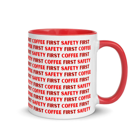 White ceramic mug with red repeating text that says "Safety First, Coffee First" with a red rim, inside, and handle.