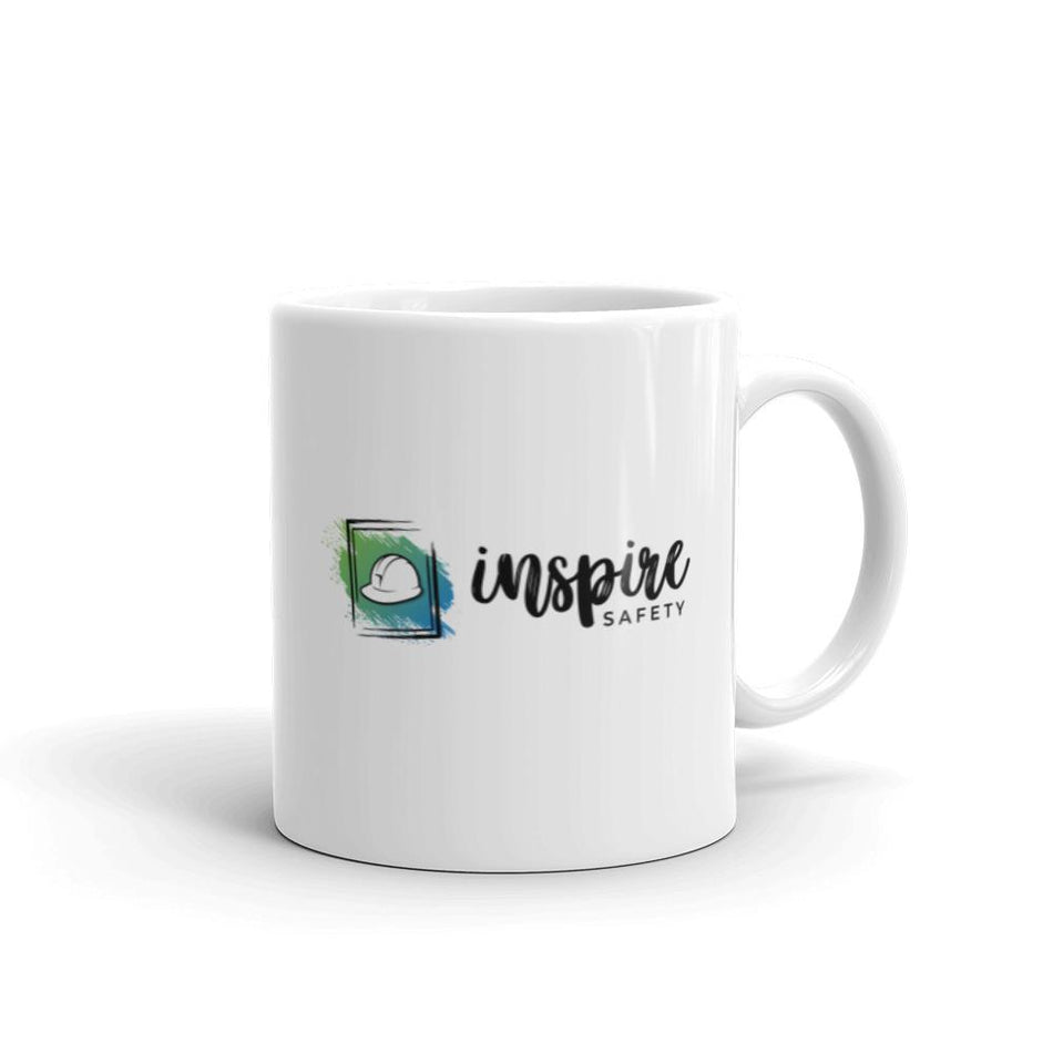 A white ceramic mug with text that says "I'm not always safe but when I am I- Just kidding, I'm always safe." with the Inspire Safety logo on the other side.