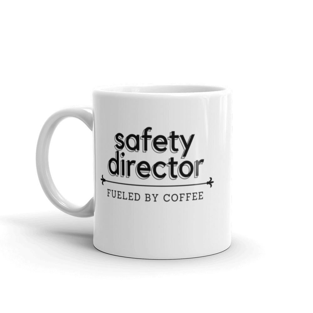 White ceramic mug with the phrase "Safety Director, fueled by coffee."